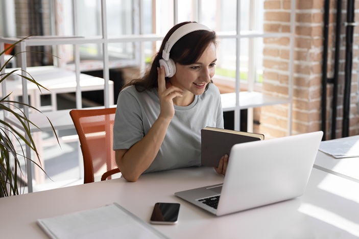 woman working with headphones medium shot