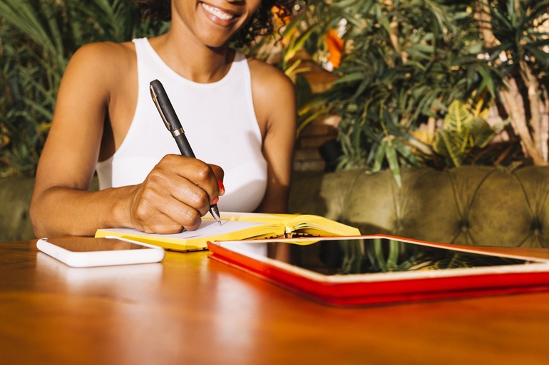 young woman writing diary